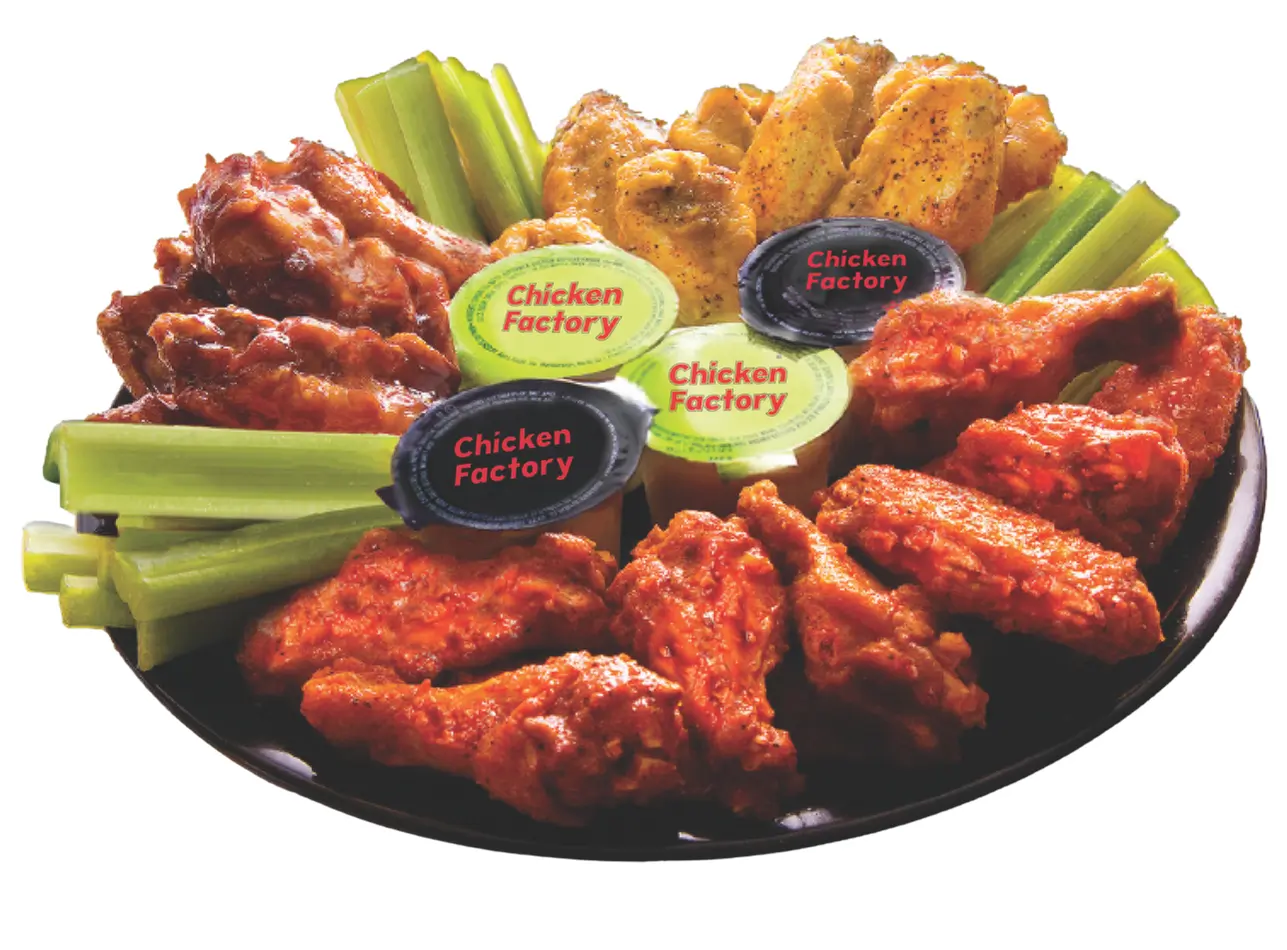 Mixed flavor chicken wings served with celery & dipping sauces at Chicken Factory, a Fast - Food Restaurant in Riverdale